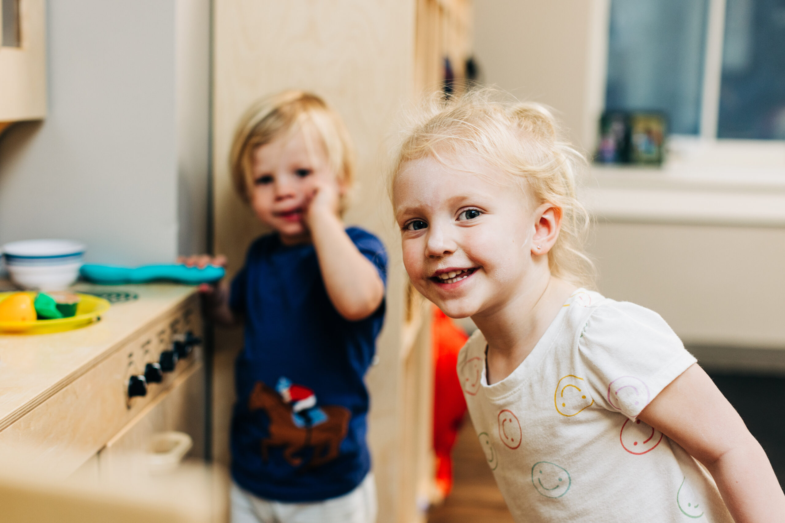 Young toddler smiling in her classroom