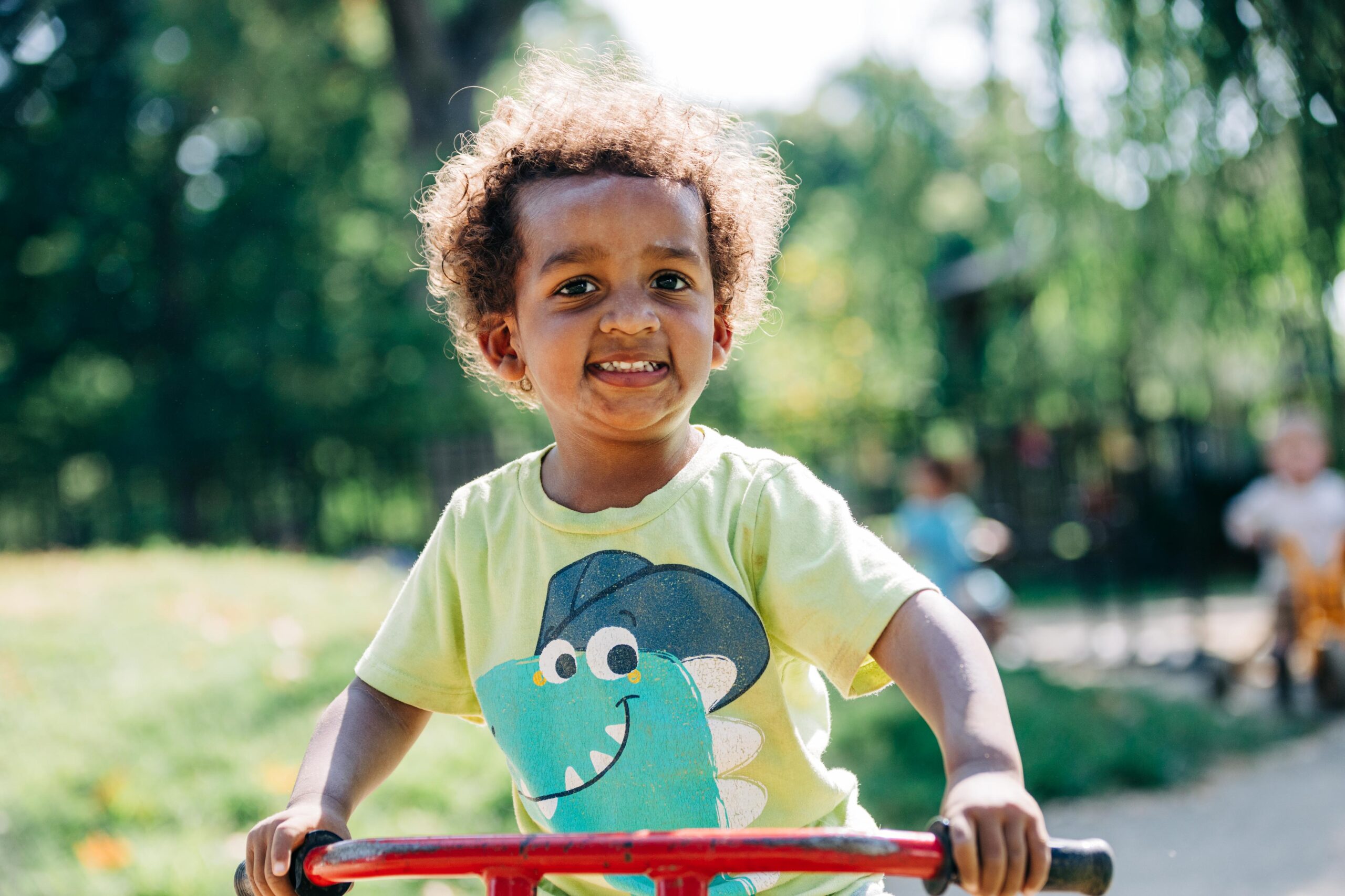 Young preschooler riding a tricycle