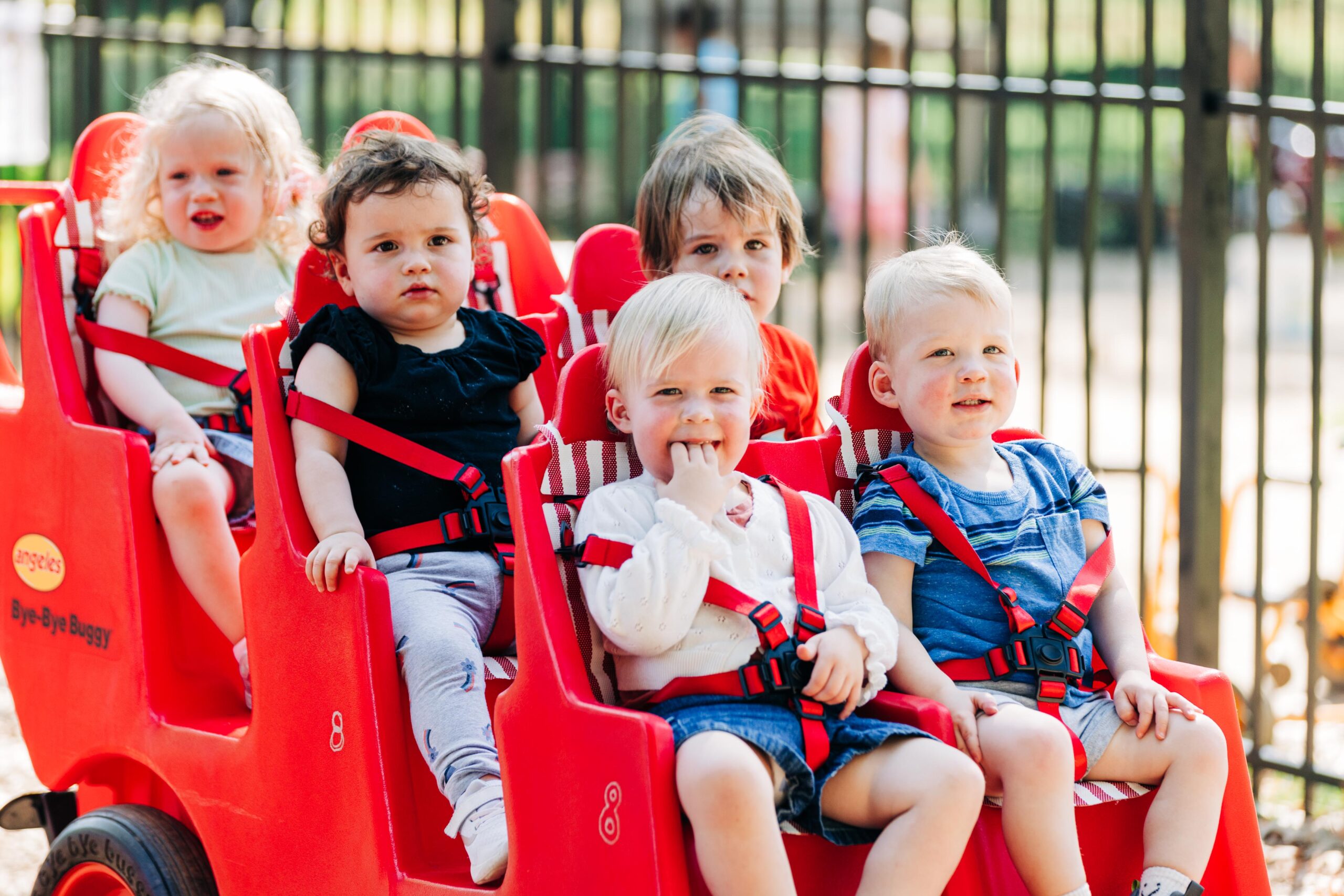 Infants riding in a 6-child stroller