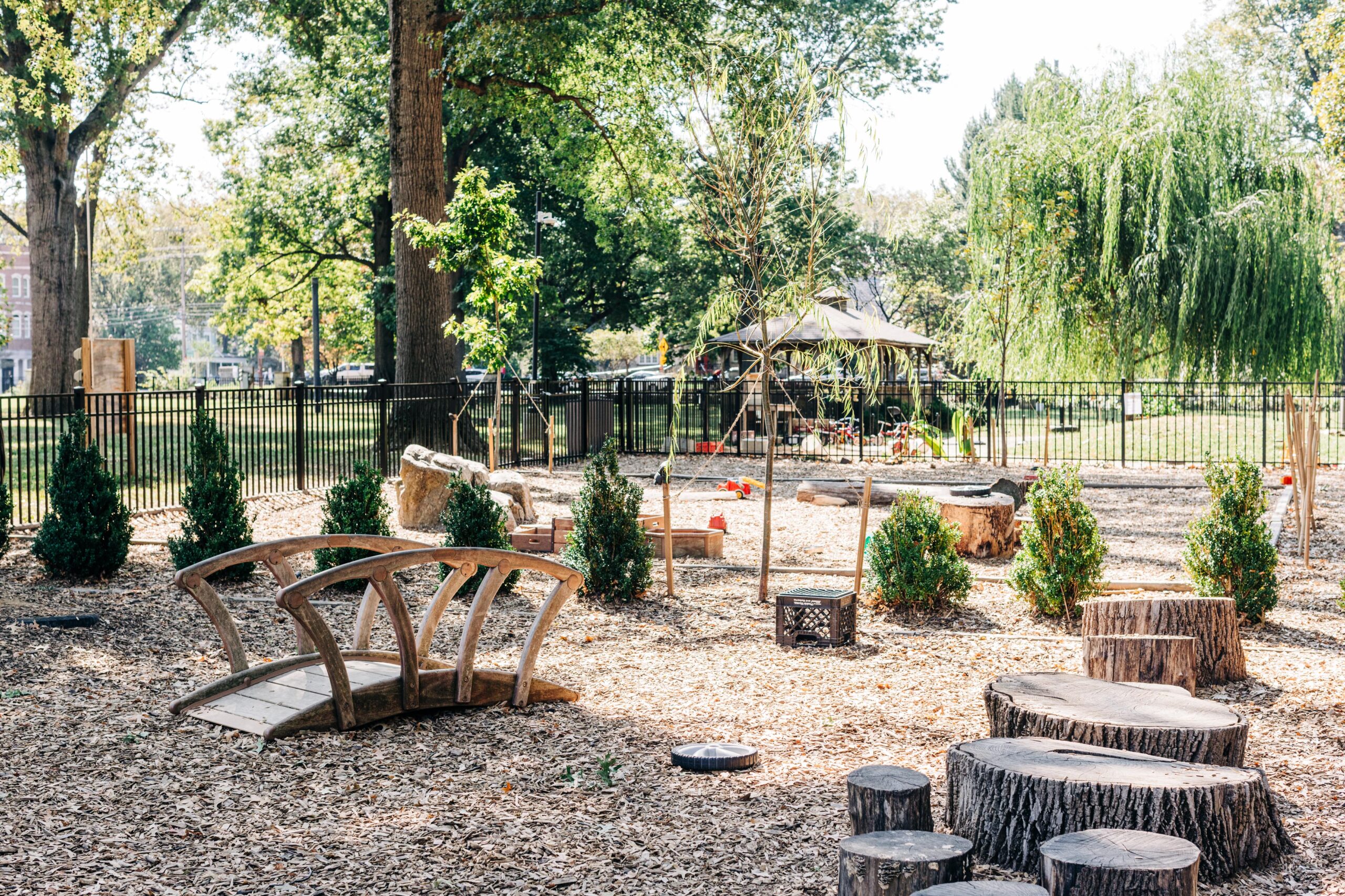 Natural playground with wooden bridge and stumps