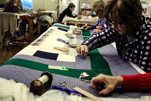 Women sewing a quilt